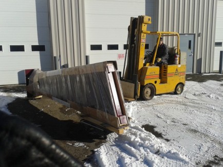 Brother-in-law Keith loading one of the 1000 lb legs with his forklift.