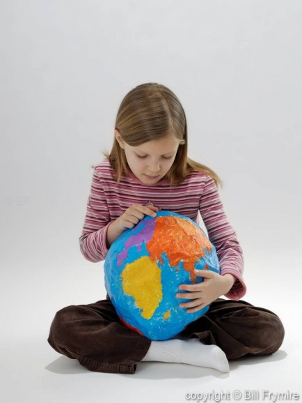 paper globe geography with young girl