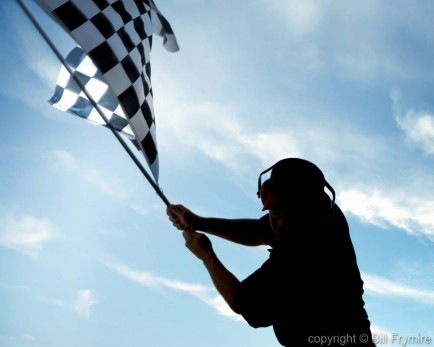 man waving checkered flag