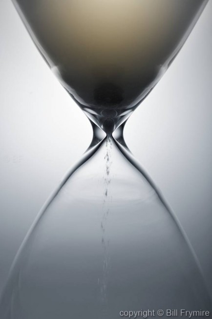 close-up of sand falling through the hourglass -