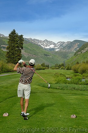 golfer driving ball on Vail Golf course