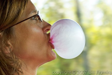 Woman blowing bubble gum