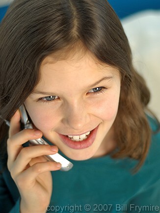 Pre-teenage girl talking on a cell phone. - cellphone-girl-talk-close-up
