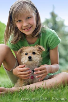 Child playing with a puppy