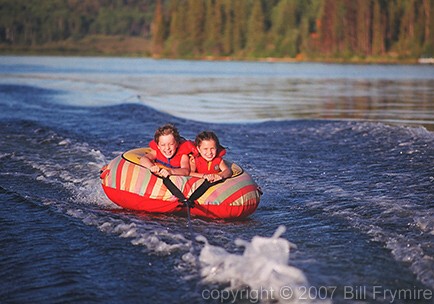 two children water tubing