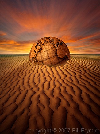 globe buried in sand dune