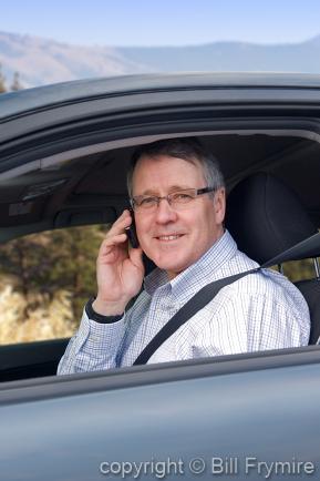 Portrait of Man Sitting in Car Talking on Cell Phone