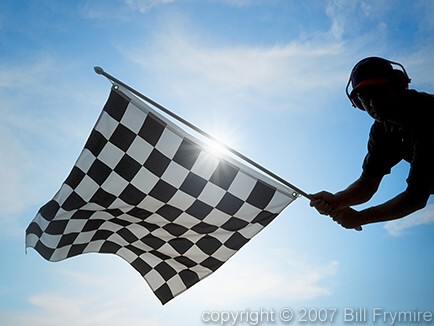 man waving checkered flag