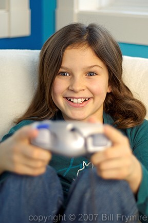 Tween girl playing game system 