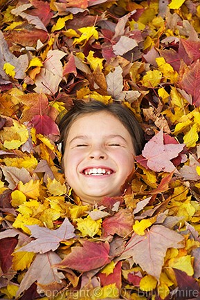girl lying in leaves