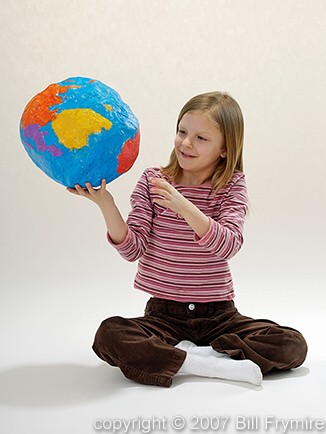 young girl holding globe in her hand