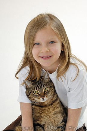 girl holding cat on lap