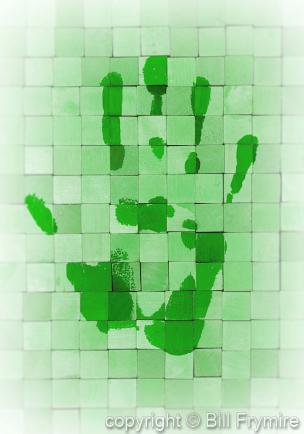 Green hand print on wooden blocks 