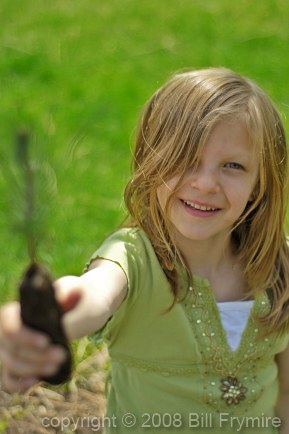 Young girl planting tree seedling