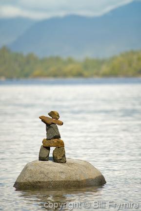 Inukshuk on a rock in the ocean