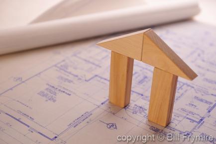 wooden block house on blueprints