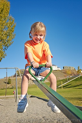 girl on teeter totter in playground