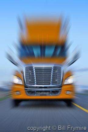 truck driving on road with motion blur