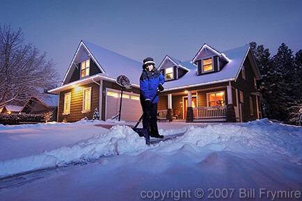 woman shoveling snow off driveway