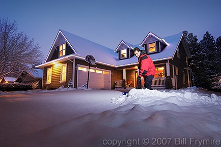 man shoveling snow off driveway