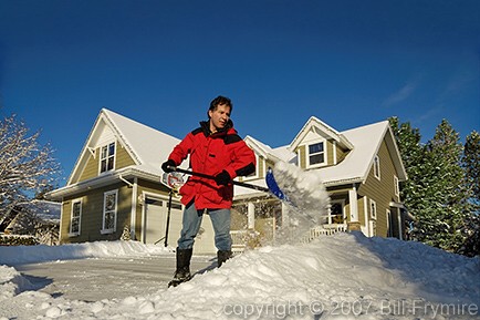 man shoveling snow from driveway