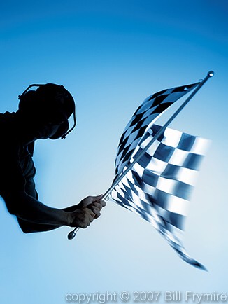 man waving checkered flag