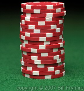 stack of red poker chips green felt