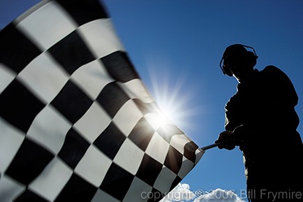 man waving checkered flag