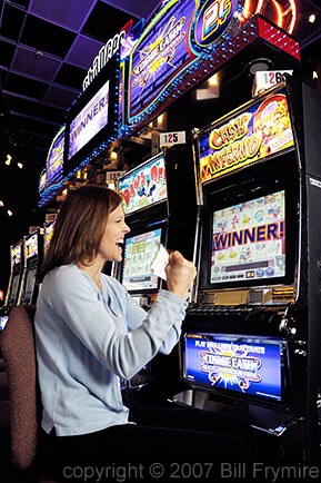 woman playing slot machines at casino