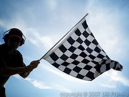 man waving checkered flag