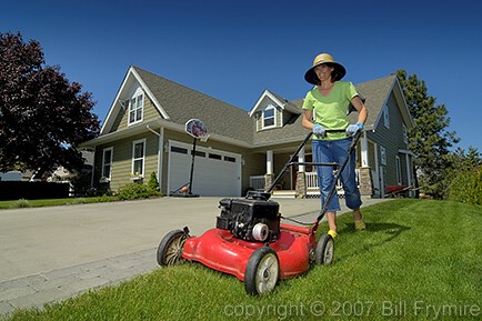 woman mowing lawn