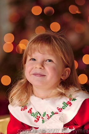 girl in front of Christmas tree