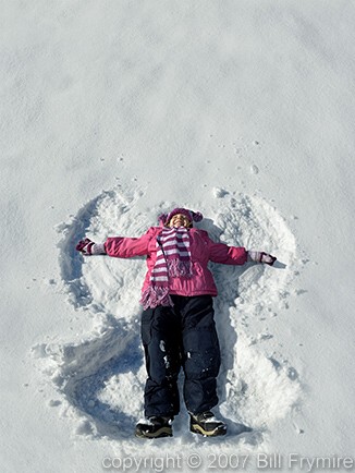 girl making snow angel