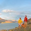 couple walking dog by lake