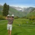 golfer driving ball on Vail Golf course