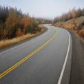 Curved road with morning mist.