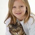 girl holding cat on lap