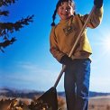 young girl raking leaves