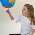 young girl spinning globe on finger