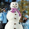 Two girls building snowman