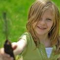 Young girl planting tree seedling