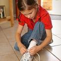 girl tying shoelaces