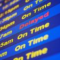 Airport Arrival board display "Delayed" and "On Time"