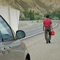 man walking for gas on highway