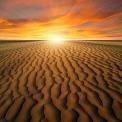 sunset in desert over sand dunes