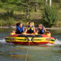 three girls tubing on a lake