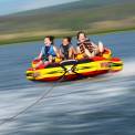 three children tubing on the lake