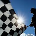 man waving checkered flag