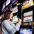 woman playing slot machines at casino