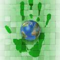 Green hand print with world globe 